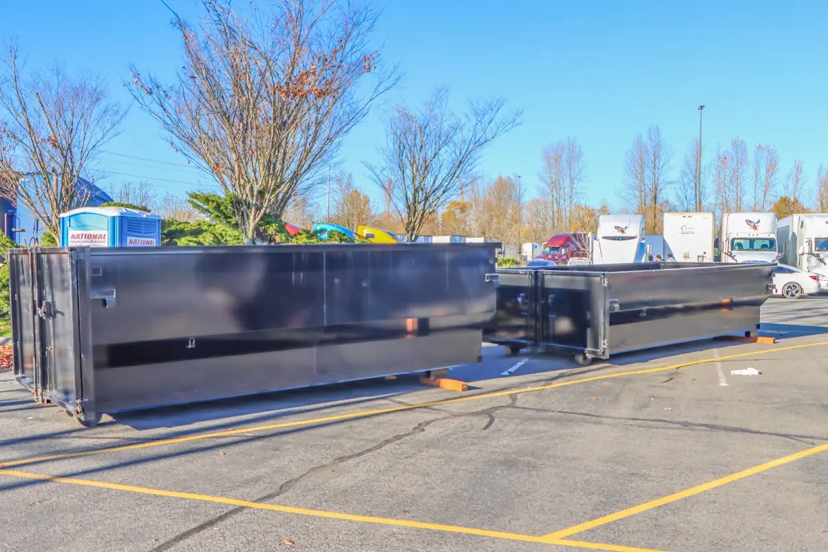 Professional dumpster rental service with roll-off container on residential driveway in Madison